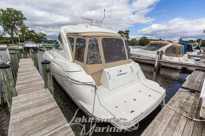 Slide: The Image of 2006 Cruisers Yachts 420 Express docked at marina, featuring sleek design and spacious deck. - 18