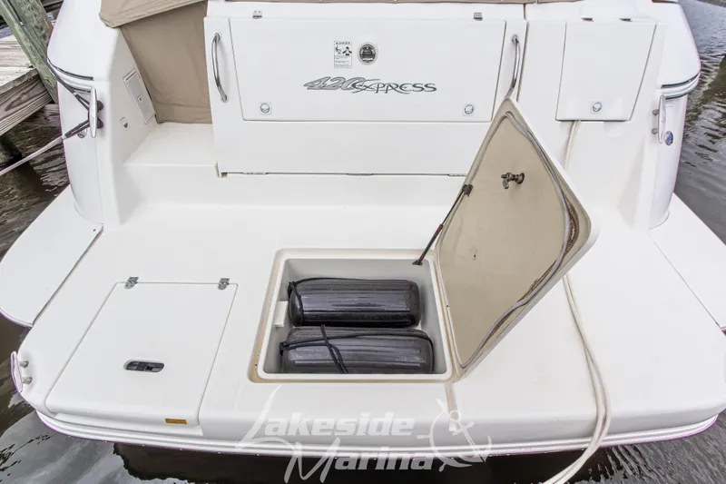 Slide: The Image of 2006 Cruisers Yachts 420 Express swim platform with storage compartment open. - 22