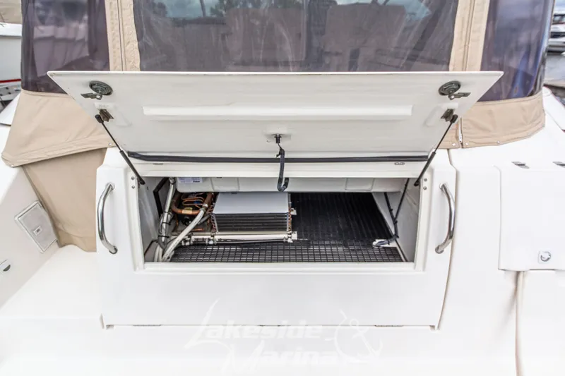 Slide: The Image of 2006 Cruisers Yachts 420 Express storage compartment with open hatch, showcasing interior details. - 23