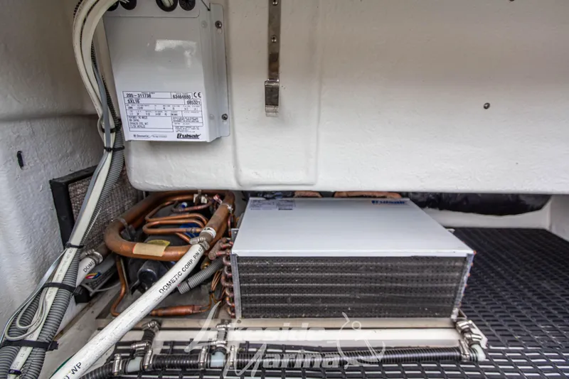 Slide: The Image of Engine room of 2006 Cruisers Yachts 420 Express, showcasing electrical components and wiring. - 24
