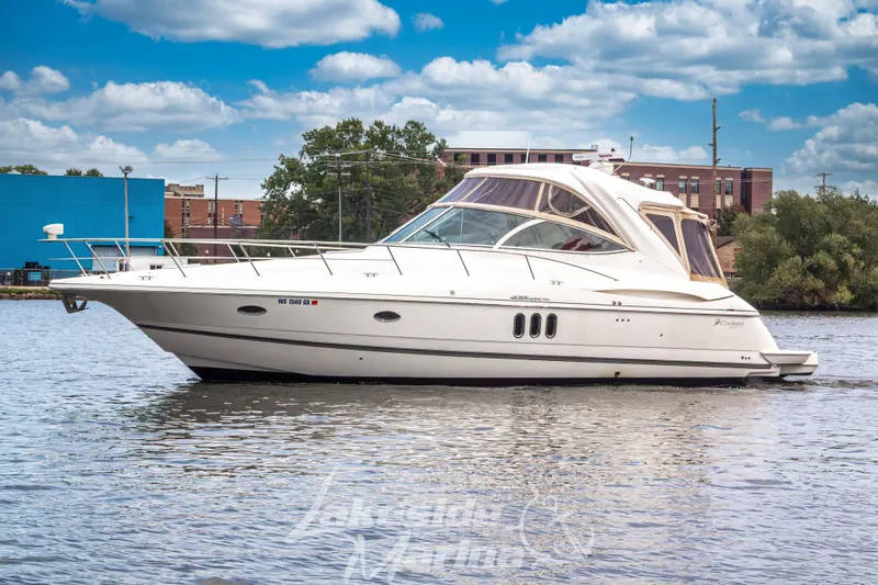 Slide: The Image of 2006 Cruisers Yachts 420 Express on water, cityscape background, partly cloudy sky. - 3