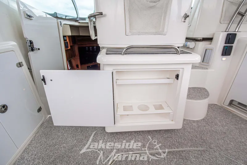 Slide: The Image of 2006 Cruisers Yachts 420 Express interior with open storage compartment and carpeted flooring. - 31