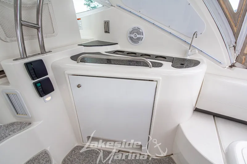 Slide: The Image of 2006 Cruisers Yachts 420 Express interior with sleek white cabinetry and modern design. - 32