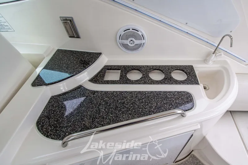 Slide: The Image of 2006 Cruisers Yachts 420 Express boat interior with sleek countertop and sink. - 33