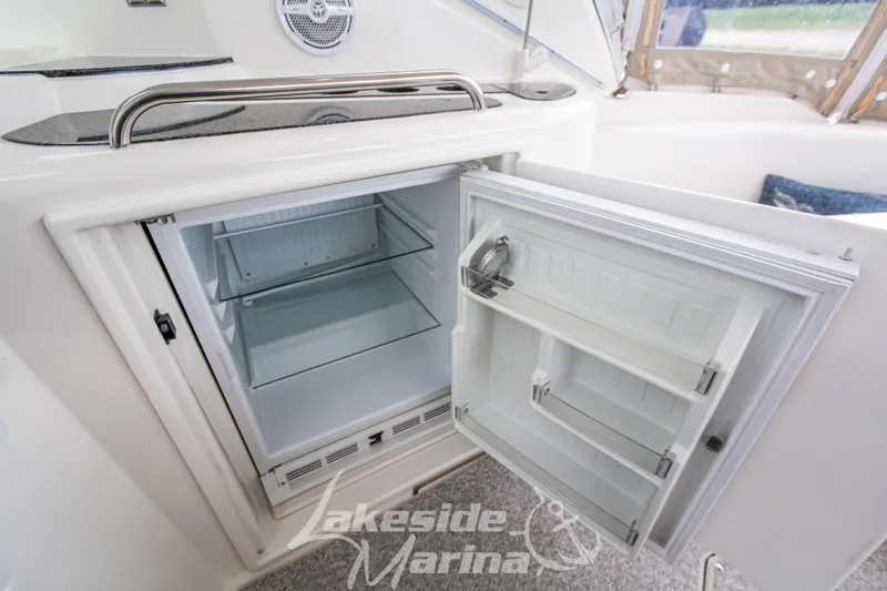 Slide: The Image of Open refrigerator on 2006 Cruisers Yachts 420 Express, showcasing interior shelves. - 34