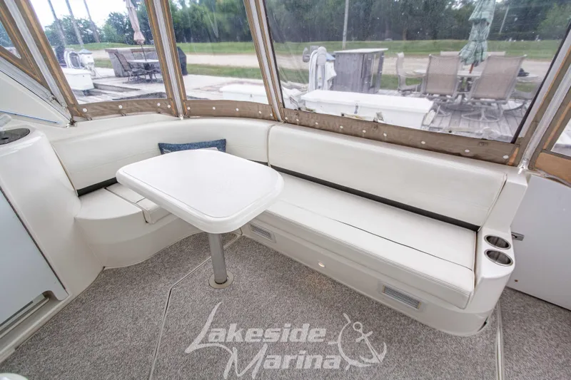 Slide: The Image of 2006 Cruisers Yachts 420 Express interior with seating and table, Lakeside Marina. - 36