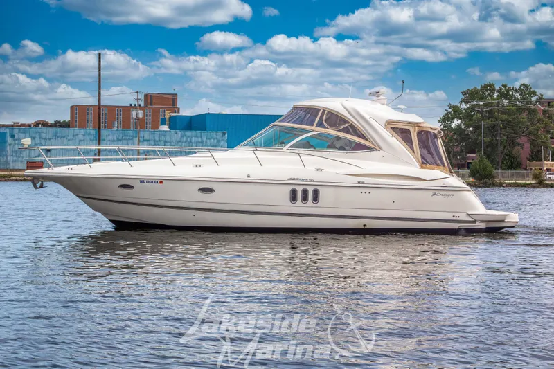 Slide: The Image of 2006 Cruisers Yachts 420 Express on calm water, showcasing sleek design and luxury features. - 4