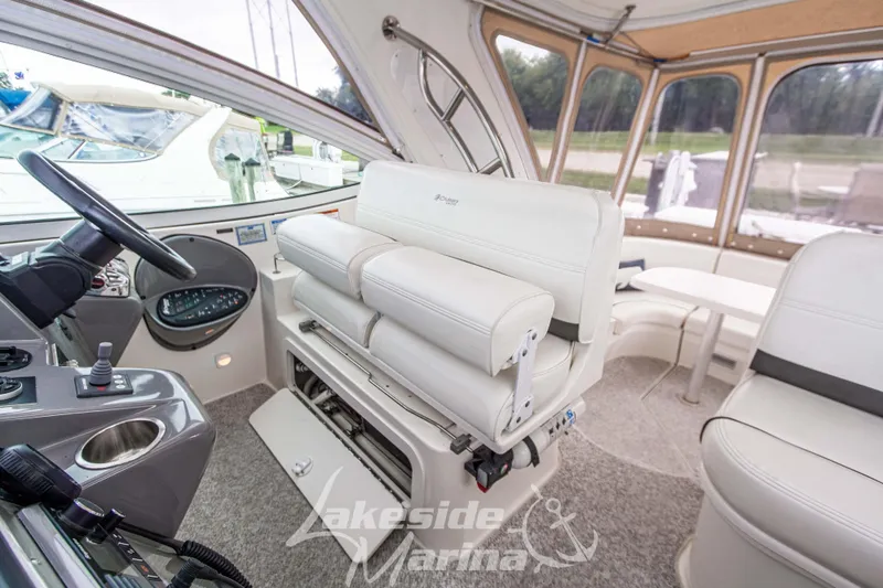 Slide: The Image of 2006 Cruisers Yachts 420 Express interior with helm, seating, and panoramic windows. - 44
