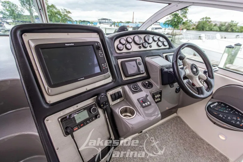 Slide: The Image of 2006 Cruisers Yachts 420 Express helm with navigation equipment and steering wheel. - 46