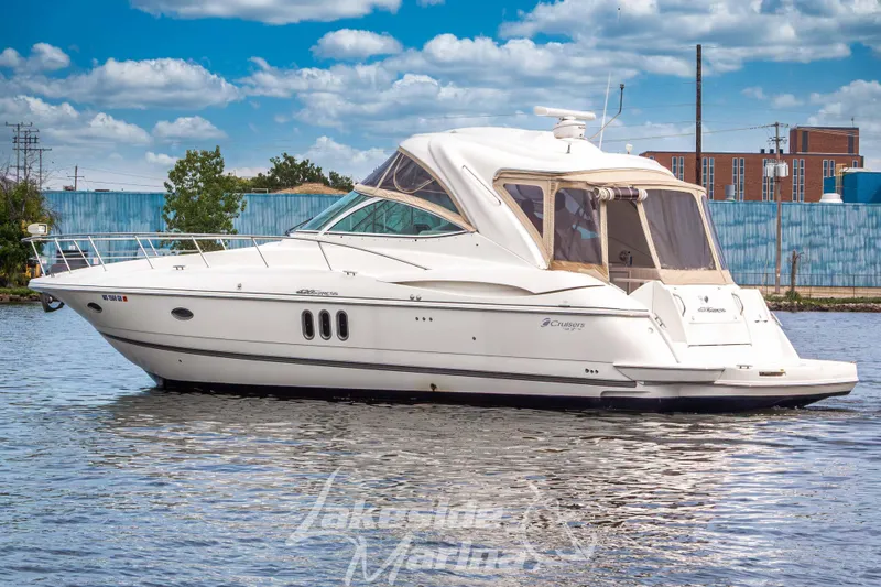 Slide: The Image of 2006 Cruisers Yachts 420 Express on water, sleek design, clear sky background. - 5