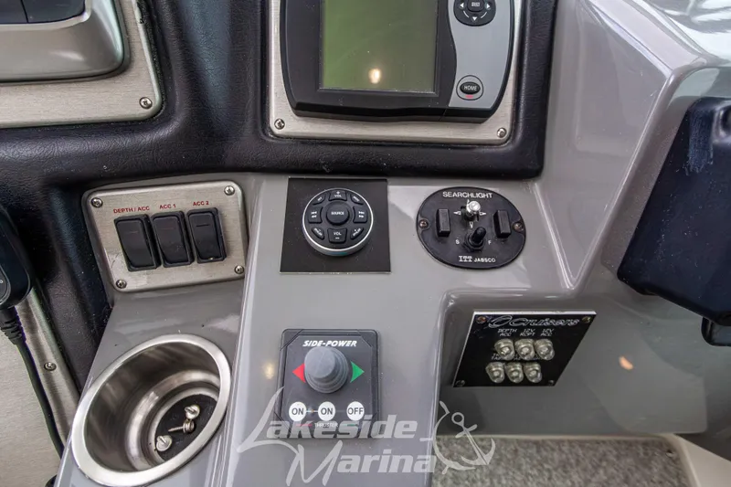 Slide: The Image of Control panel of a 2006 Cruisers Yachts 420 Express with various switches and controls. - 52