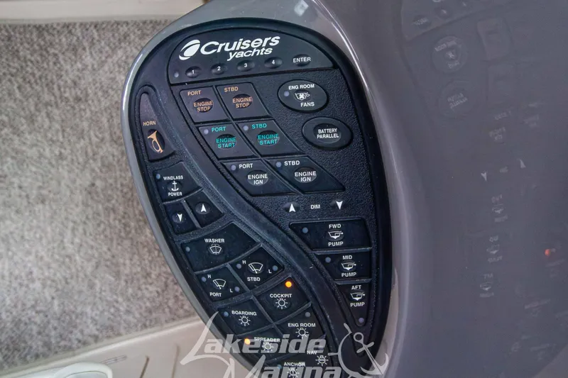 Slide: The Image of Control panel of 2006 Cruisers Yachts 420 Express with various engine and system buttons. - 54