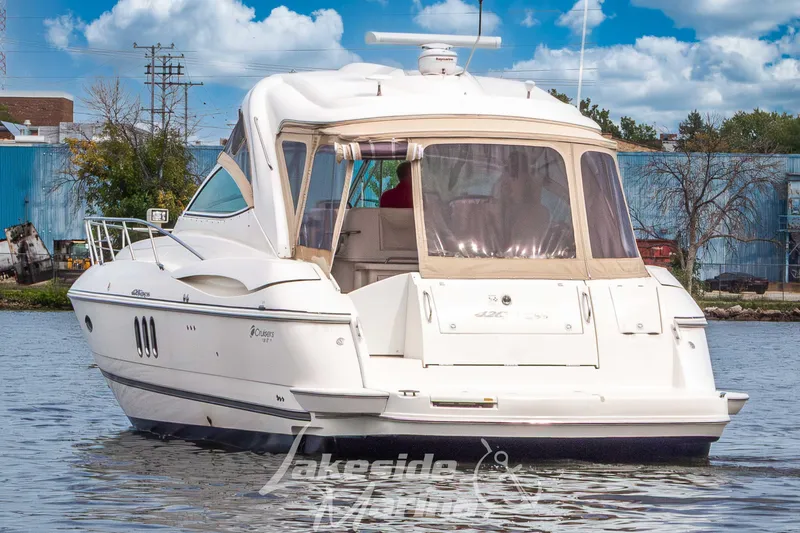Slide: The Image of 2006 Cruisers Yachts 420 Express on water, rear view, clear sky background. - 6