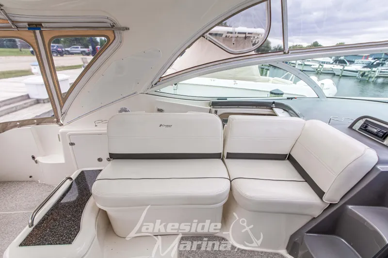 Slide: The Image of 2006 Cruisers Yachts 420 Express interior with white seating at marina. - 60