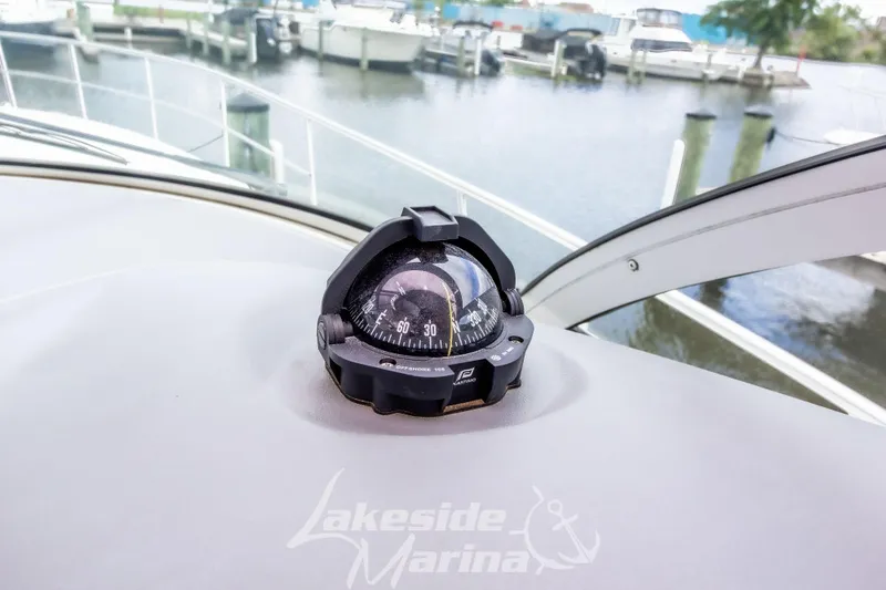Slide: The Image of Compass on 2006 Cruisers Yachts 420 Express dashboard at marina. - 63