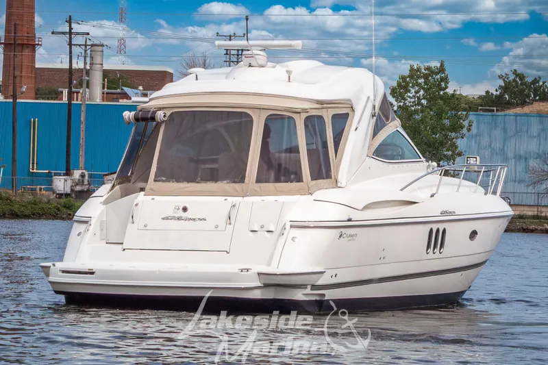 Slide: The Image of 2006 Cruisers Yachts 420 Express on water, featuring sleek design and spacious cabin. - 7