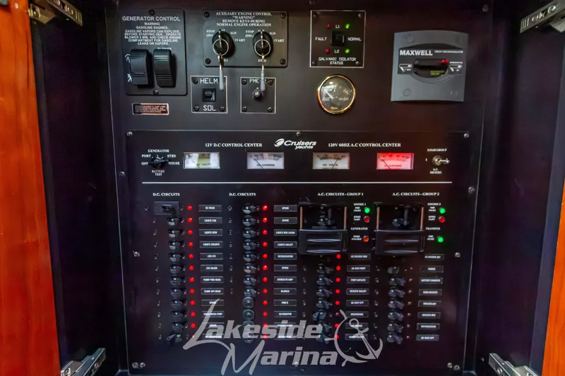 Slide: The Image of Control panel of 2006 Cruisers Yachts 420 Express with various switches and indicators. - 74