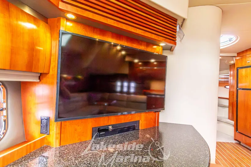 Slide: The Image of Interior of 2006 Cruisers Yachts 420 Express with TV and wood cabinetry. - 77