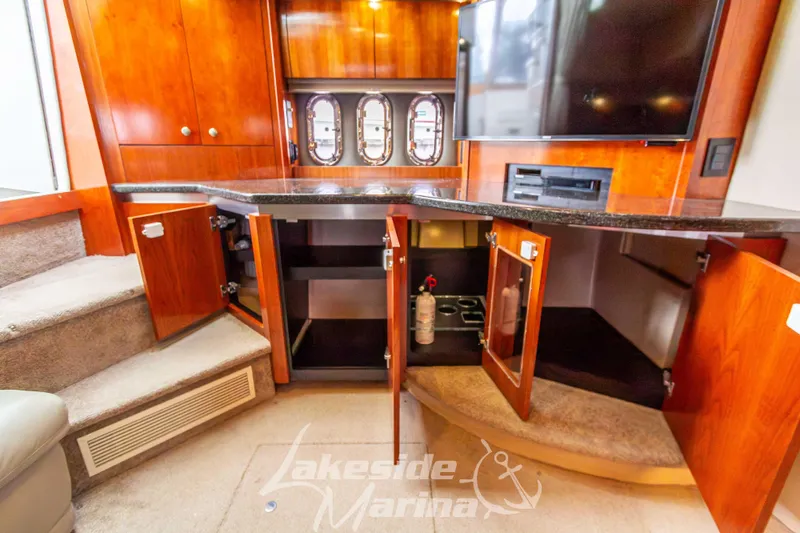 Slide: The Image of Interior of 2006 Cruisers Yachts 420 Express with open cabinets and modern amenities. - 79