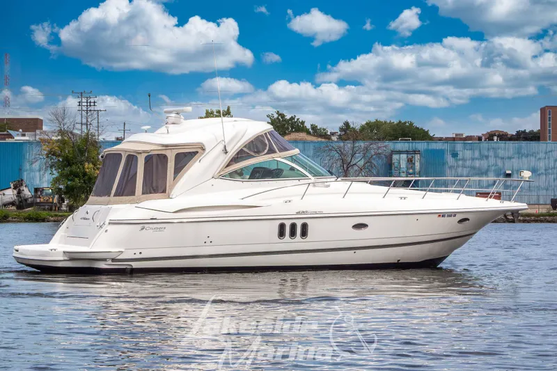 Slide: The Image of 2006 Cruisers Yachts 420 Express on water, clear sky, urban backdrop. - 8