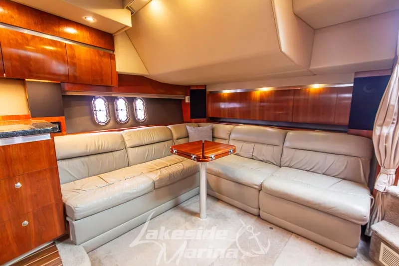 Slide: The Image of Luxurious interior of 2006 Cruisers Yachts 420 Express with leather seating and wooden cabinetry. - 80