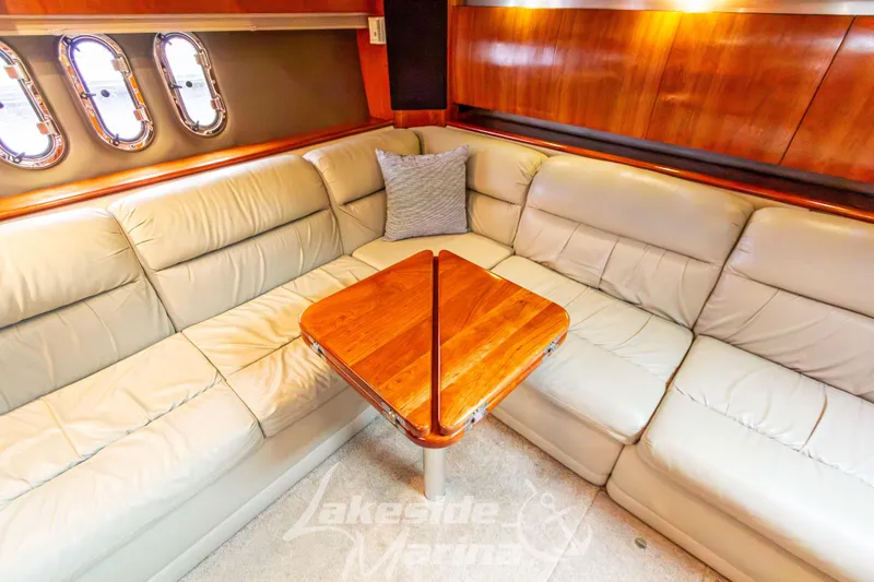 Slide: The Image of Luxurious interior of 2006 Cruisers Yachts 420 Express with leather seating and wooden table. - 81