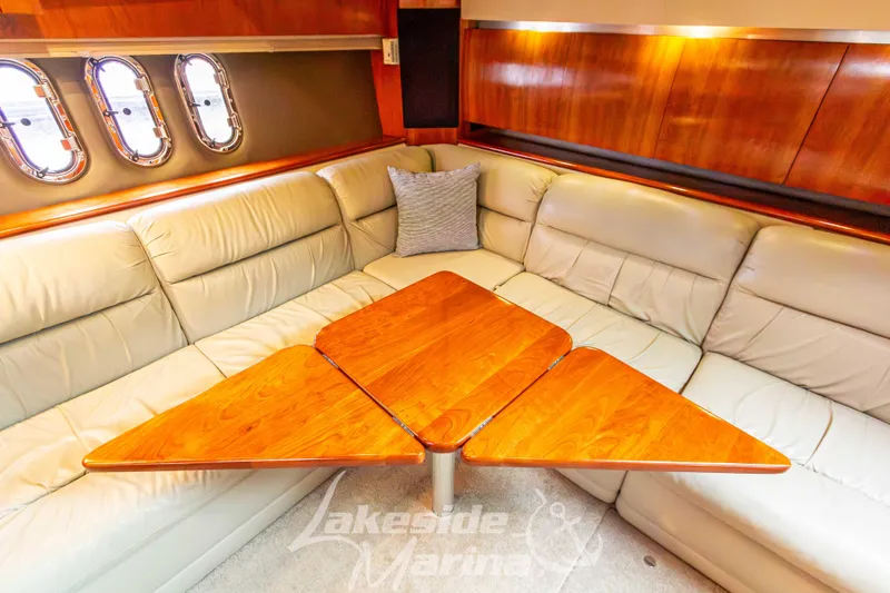 Slide: The Image of Luxurious 2006 Cruisers Yachts 420 Express interior with plush seating and wooden table. - 82