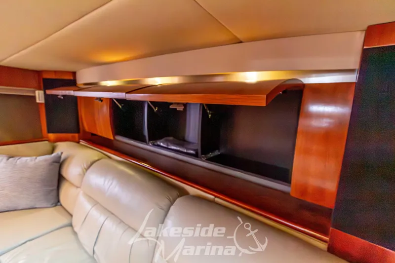 Slide: The Image of Interior of 2006 Cruisers Yachts 420 Express with open wooden cabinets and leather seating. - 84