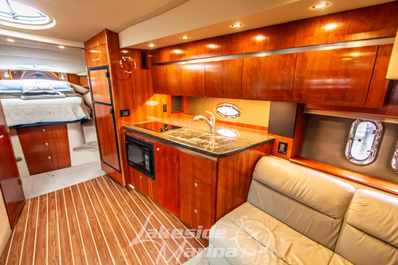 Slide: The Image of Luxurious 2006 Cruisers Yachts 420 Express interior with wood cabinetry and modern amenities. - 88
