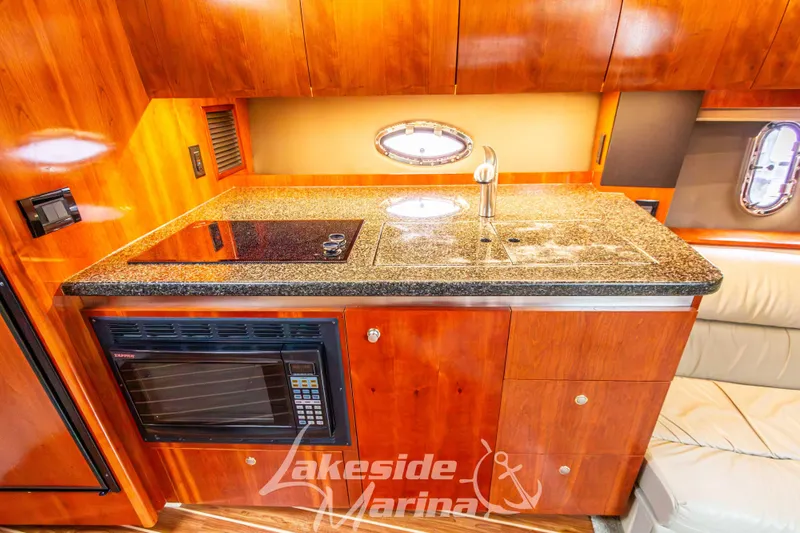 Slide: The Image of 2006 Cruisers Yachts 420 Express kitchen with granite countertop and modern appliances. - 90