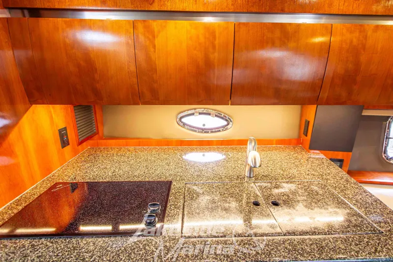 Slide: The Image of Luxurious 2006 Cruisers Yachts 420 Express kitchen with granite countertop and modern fixtures. - 93