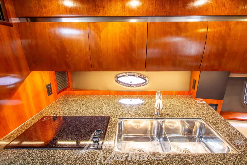 Slide: The Image of 2006 Cruisers Yachts 420 Express kitchen with granite countertop and stainless steel sink. - 94
