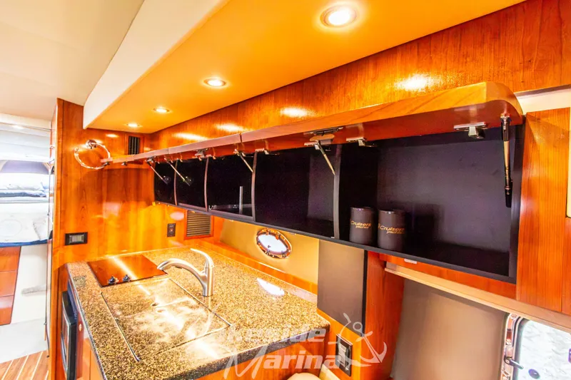 Slide: The Image of Luxurious 2006 Cruisers Yachts 420 Express interior with modern kitchen and wood finishes. - 96