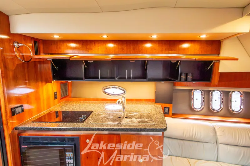 Slide: The Image of Luxurious 2006 Cruisers Yachts 420 Express interior with modern kitchen and elegant wood finish. - 97