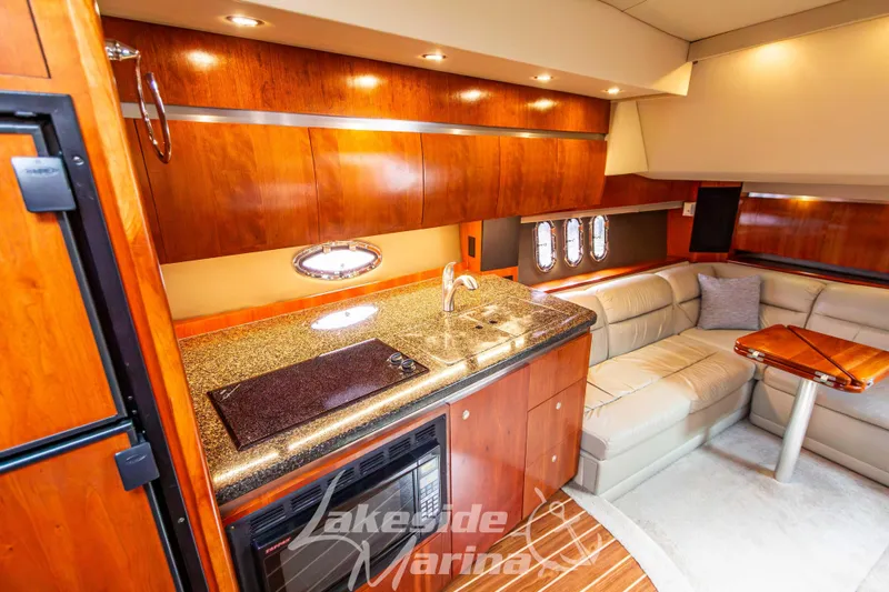 Slide: The Image of Luxurious interior of 2006 Cruisers Yachts 420 Express with kitchenette and seating area. - 98