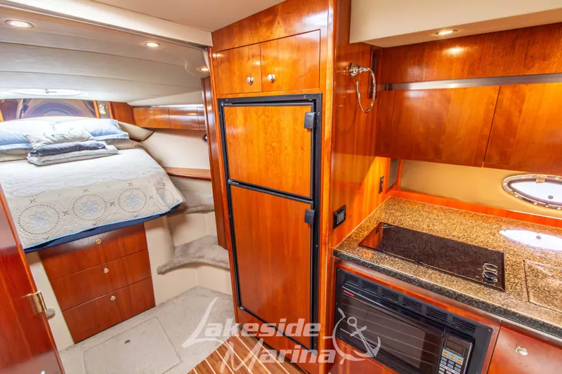 Slide: The Image of Luxurious 2006 Cruisers Yachts 420 Express interior with cozy bed and modern kitchenette. - 99