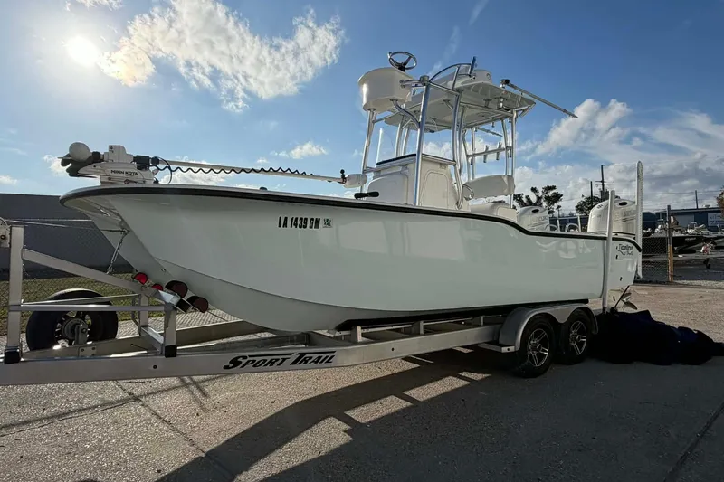 Slide: The Image of 2020 Tideline 235 Hybrid boat on trailer under clear blue sky. - 1