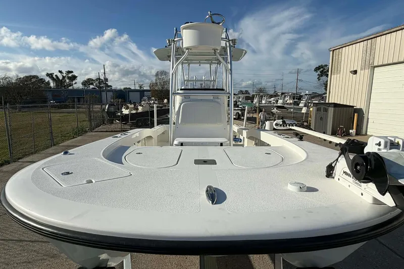 Slide: The Image of 2020 Tideline 235 Hybrid boat with spacious deck and tower, docked outdoors. - 10