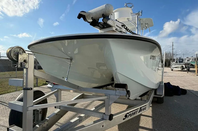 Slide: The Image of 2020 Tideline 235 Hybrid boat on trailer under clear blue sky. - 18