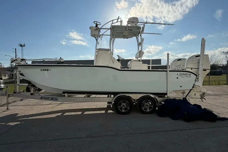 Slide: The Image of 2020 Tideline 235 Hybrid boat on trailer under clear sky. - 20