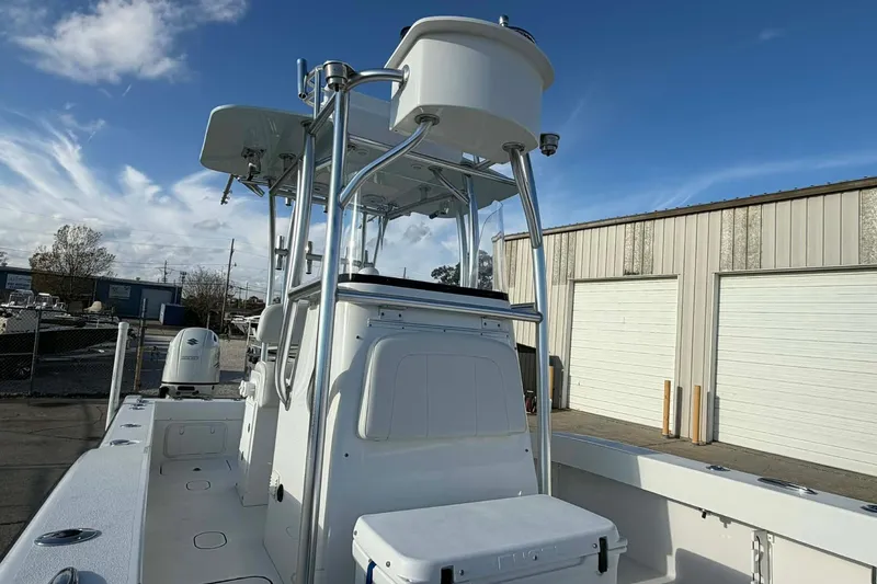 Slide: The Image of 2020 Tideline 235 Hybrid boat with T-top and storage, docked outdoors. - 21