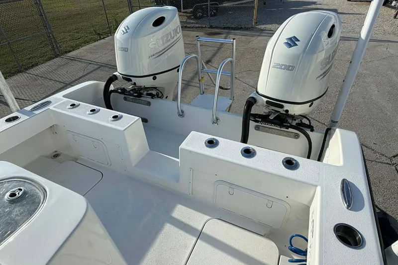 Slide: The Image of 2020 Tideline 235 Hybrid boat with dual Suzuki 200 outboard engines, docked on concrete. - 27