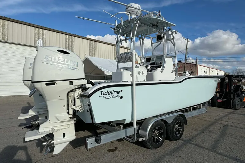 Slide: The Image of 2020 Tideline 235 Hybrid boat with Suzuki engines on a trailer, parked outdoors. - 4