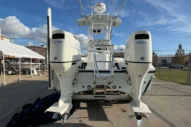Slide: The Image of 2020 Tideline 235 Hybrid boat with dual Suzuki 200 engines, parked outdoors. - 6