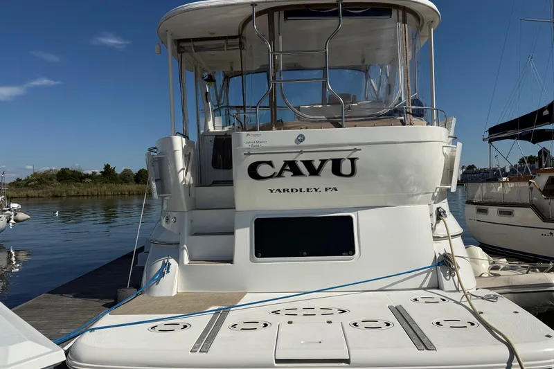 Slide: The Image of 2001 Cruisers 4450 ACMY yacht docked, featuring "CAVU" name and Yardley, PA location. - 2