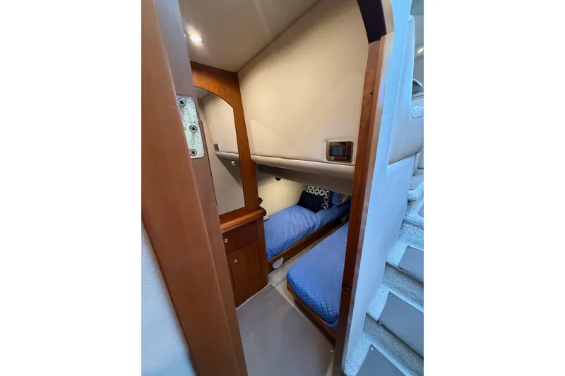 Slide: The Image of Interior cabin of 2001 Cruisers 4450 ACMY yacht with blue bedding. - 26