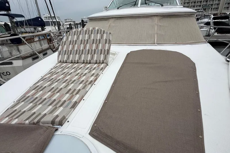 Slide: The Image of 2001 Cruisers 4450 ACMY yacht with patterned and solid sunbathing cushions on deck. - 6