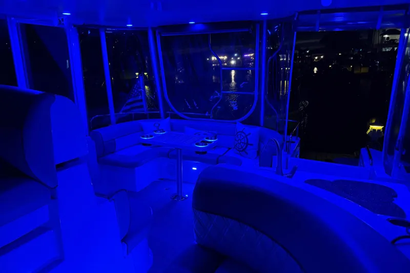 Slide: The Image of Interior of 2001 Cruisers 4450 ACMY yacht with blue ambient lighting at night. - 9