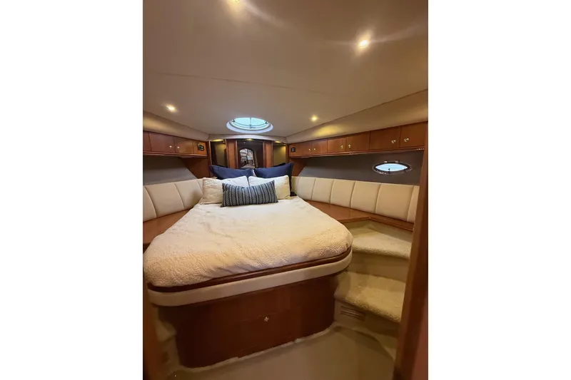 Slide: The Image of Luxurious cabin interior of 2001 Cruisers 4450 ACMY yacht with cozy bed and ambient lighting. - 21