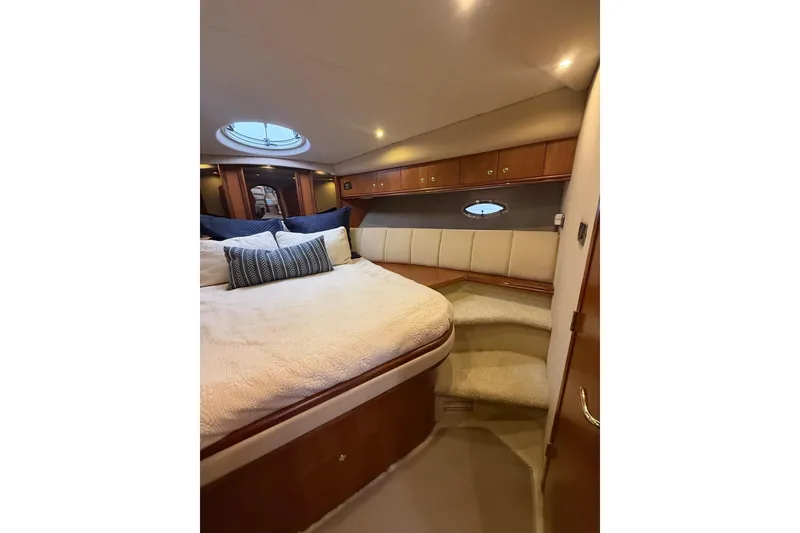 Slide: The Image of Luxurious cabin interior of 2001 Cruisers 4450 ACMY yacht with cozy bed and elegant wood finish. - 22